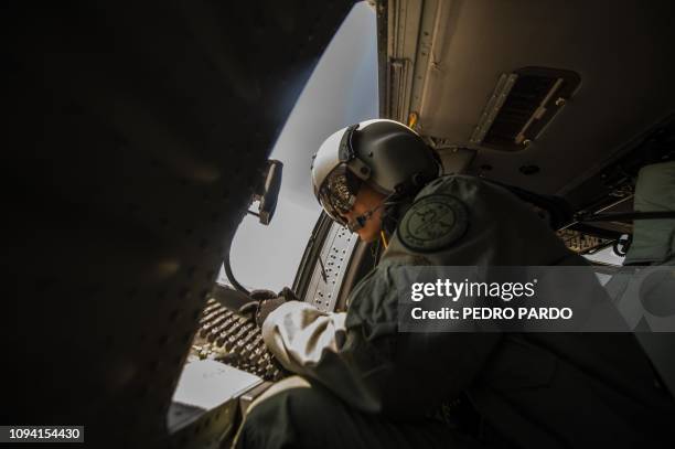 Soldiers on an Air Force Blackhawk helicopter fly over the Mexican state of Guanajuato on February 4, 2019 during an operation to fight illegal taps...