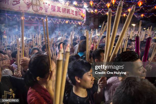 People wait to pray at a temple on the eve of the Lunar New Year of the Pig on February 4, 2019 in Singapore on February 4, 2019 in Singapore.