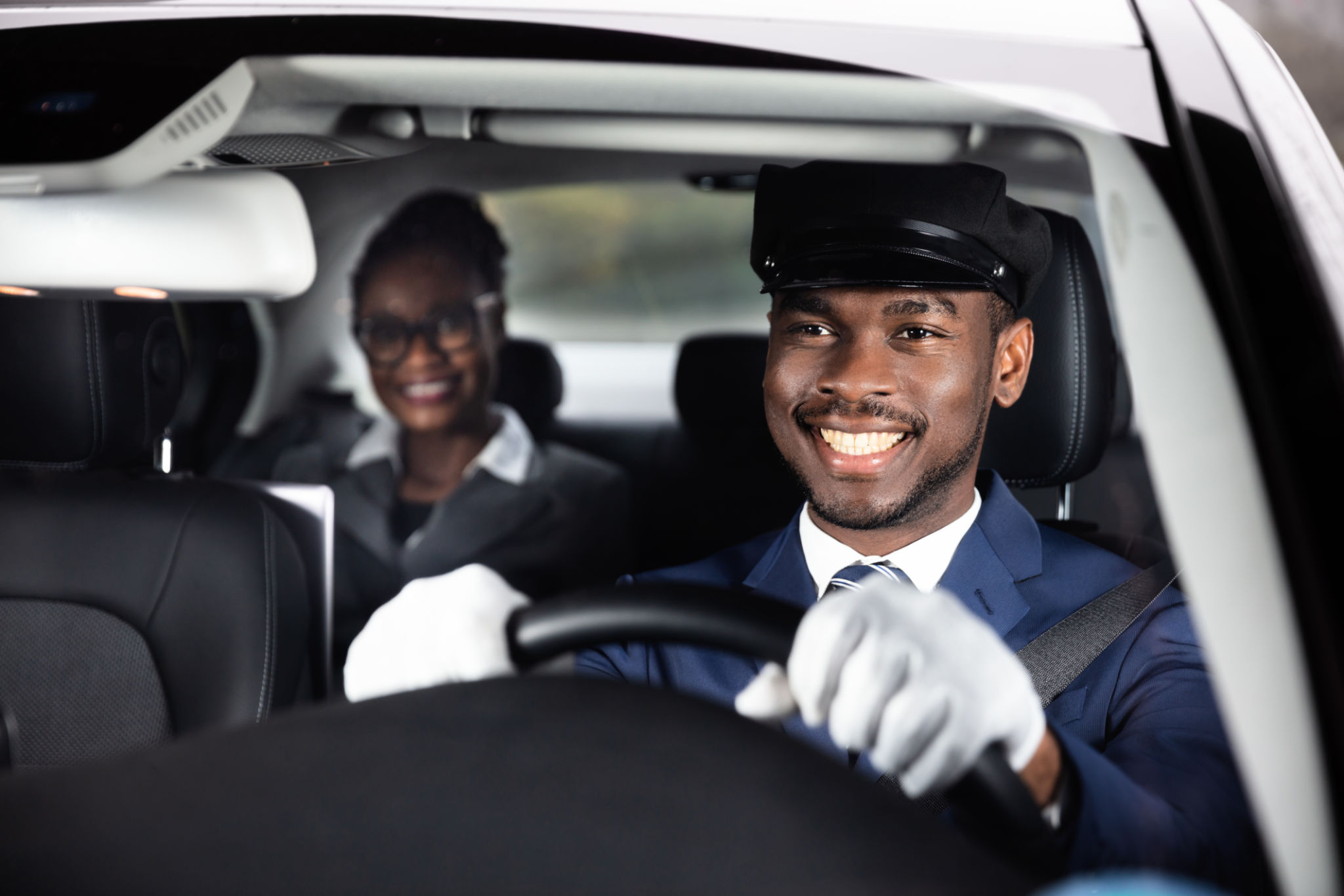 Close-up Of Happy Male Chauffeur Driving Car Close-up Of Happy Male Chauffeur Driving Car