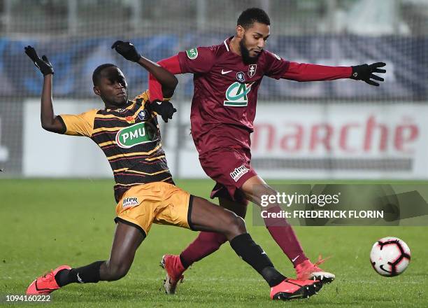 Metz' French forward Marvin Gakpa vies with Orleans' Senegalese midfielder Joseph Lopy during the French Cup round of 16 football match Football Club...