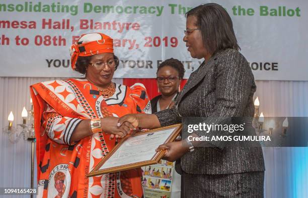 Malawi former President Joyce Banda formaly presents her candidature statement for the Peoples Party to Malawi Electoral Commission chair Jane Ansah...