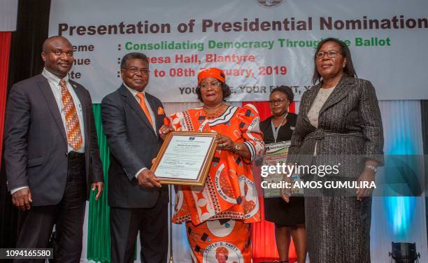Malawi former President Joyce Banda and her running mate Jerry Janda hold a certificate of candidacy, as Peoples Partys Secretary General Ibrahim...