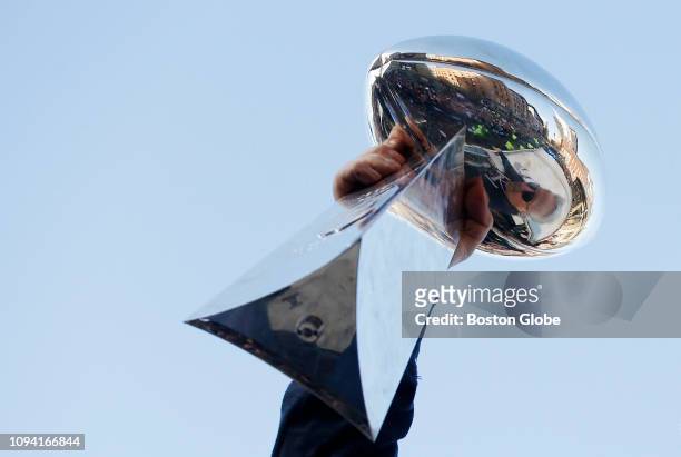 New England Patriots team owner Robert Kraft is reflected in the Vince Lombardi Trophy during the New England Patriots Super Bowl LIII victory parade...
