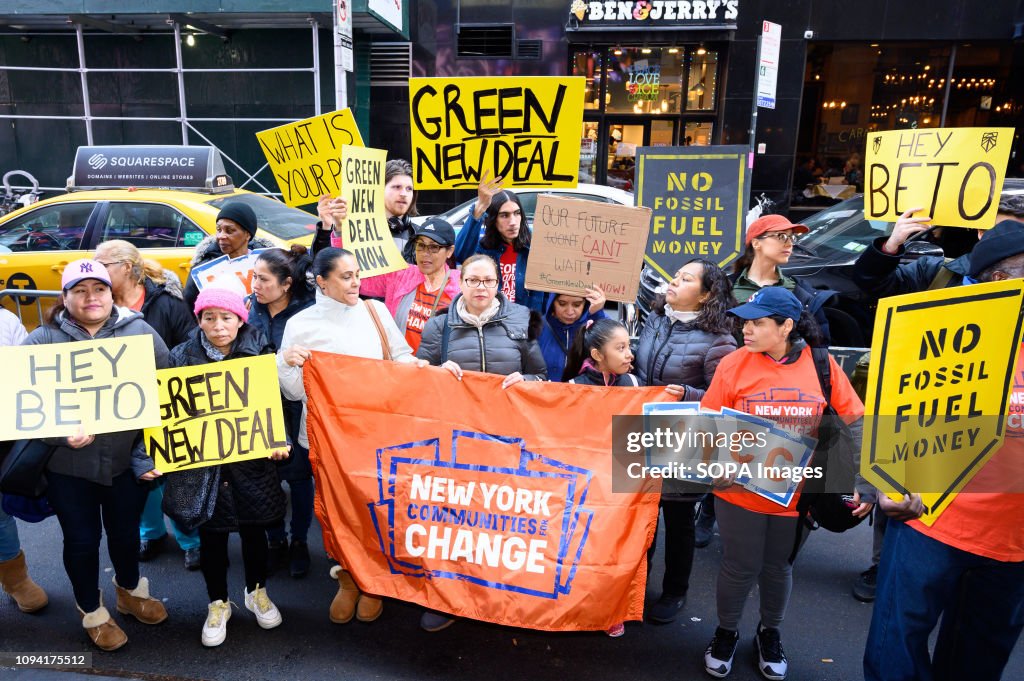 Demonstrators seen holding placards and a banner during the...