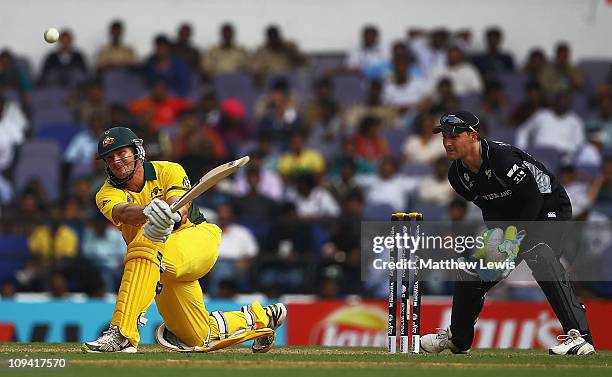 Shane Watson of Australia hits the ball towards the boundary, as Brendon McCullum of New Zealand looks on during the 2011 ICC World Cup Group A match...