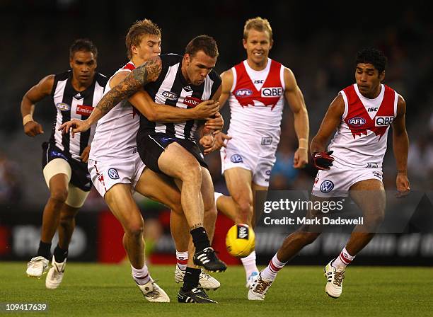 Dane Swan of the Magpies gets his kick away under pressure from the Swans during the NAB Cup Quarter Final match between the Collingwood Magpies and...