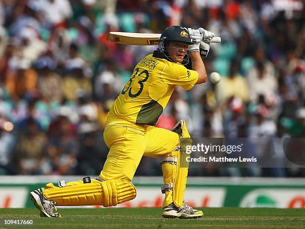 Shane Watson of Australia hits the ball towards the boundary during the 2011 ICC World Cup Group A match between Australia and New Zealand at...