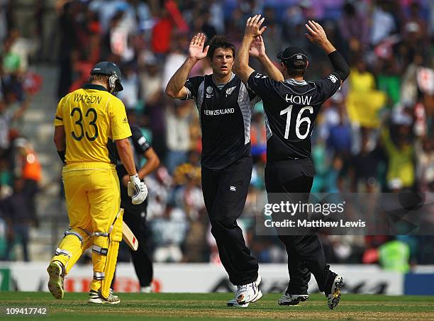 Martin Bennett of New Zealand is congratulated by Jamie How, after he bowled Shane Watson of Australia during the 2011 ICC World Cup Group A match...