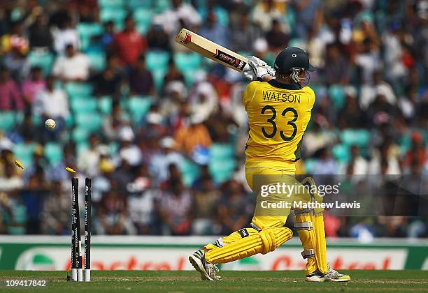 Shane Watson of Australia is bowled by Martin Bennett of New Zealand during the 2011 ICC World Cup Group A match between Australia and New Zealand at...