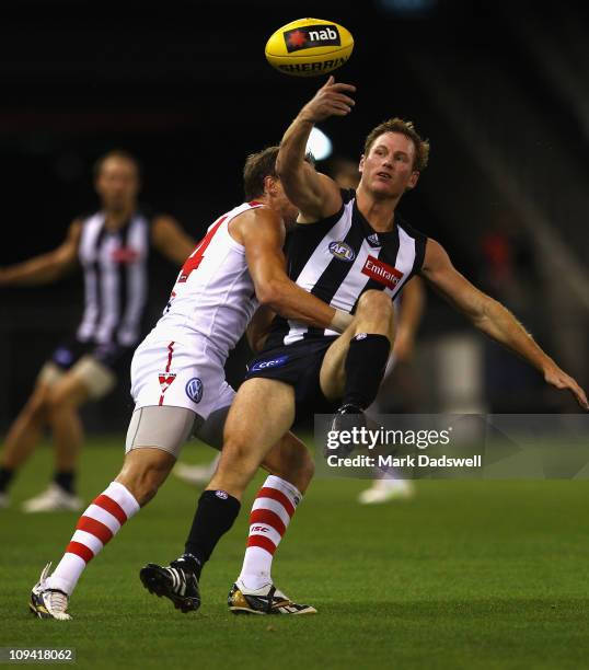 Jude Bolton of the Swans tackles Ben Johnson of the Magpies during the NAB Cup Quarter Final match between the Collingwood Magpies and the Sydney...