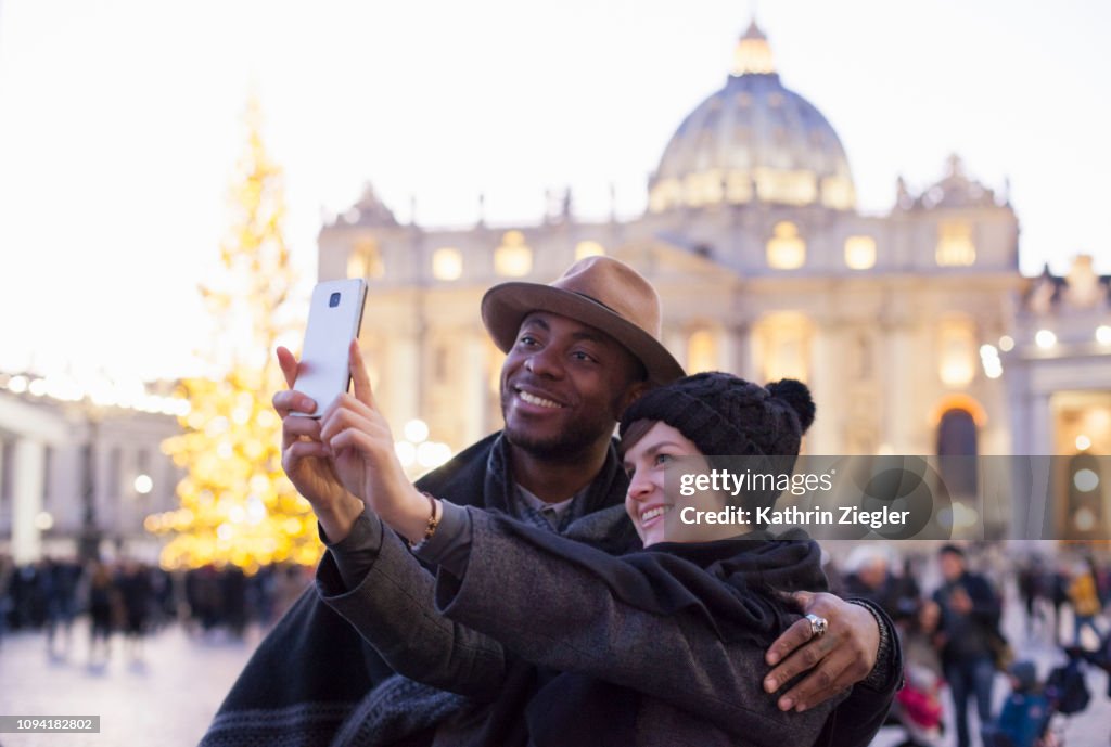 Beautiful couple taking selfie at St. Peter's Square, Rome