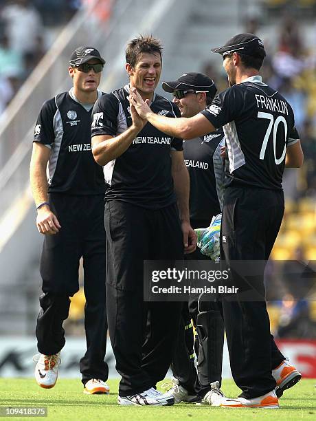 Hamish Bennett of New Zealand celebrates with team mates after taking the wicket of Brad Haddin of Australia during the 2011 ICC World Cup Group A...