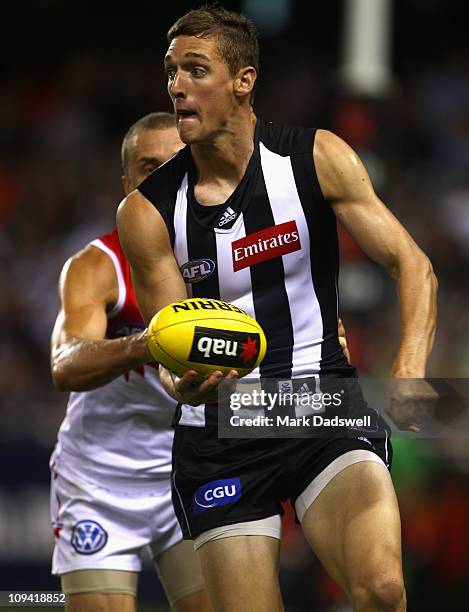 Shae McNamara of the Magpies handballs to a teammate during the NAB Cup Quarter Final match between the Collingwood Magpies and the Sydney Swans at...