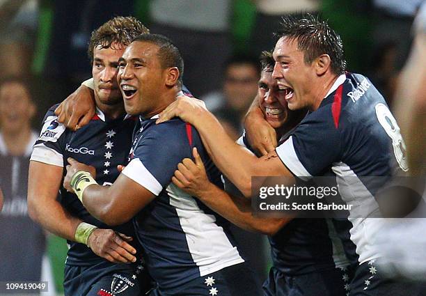 Danny Cipriani of the Rebels is congratulated by team mates Cooper Vuna and Gareth Delve at the full time whistle during the round two Super Rugby...