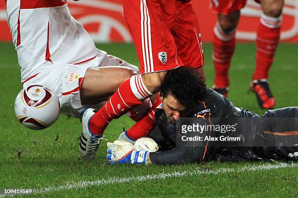 Goalkeeper Marc Ziegler of Stuttgart is hit by Nicolas Gaitan of Benfica and team mate Matthieu Delpierre during the UEFA Europa League match round...