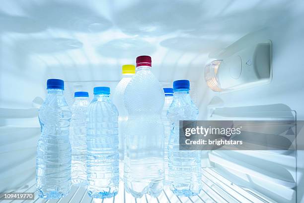 water bottles in refrigerator - water bottles in fridge stock pictures, royalty-free photos & images