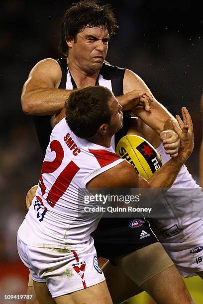 Leigh Brown of the Magpies is tackled by Ben McGlynn of the Swans during the NAB Cup Quarter Final match between the Collingwood Magpies and the...