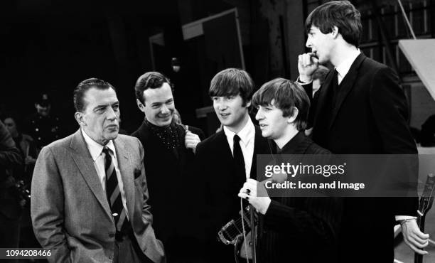 American TV host Ed Sullivan talks to English manager Brian Epstein , English singer, songwriter and guitarist John Lennon , English singer and...