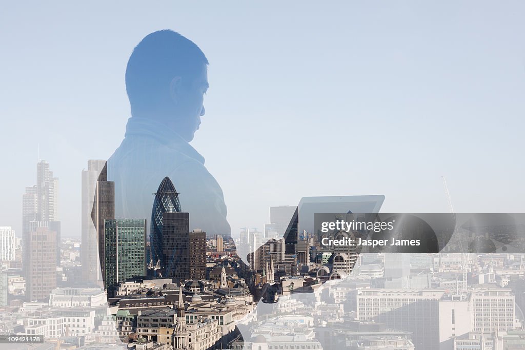 Man at laptop with cityscape