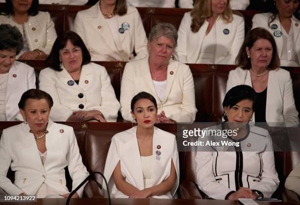 Rep. Alexandria Ocasio-Cortez watches President Donald Trump's State of the Union address in the chamber of the U.S. House of Representatives at the...