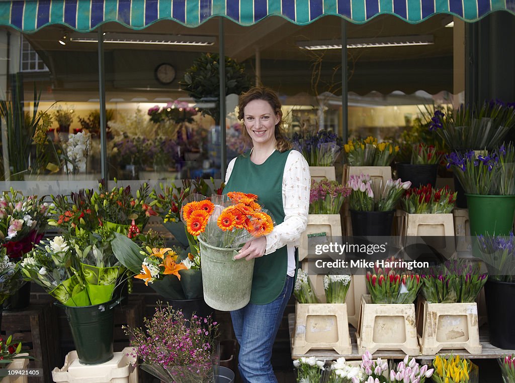 Female Florist Holding Flower Arrangement