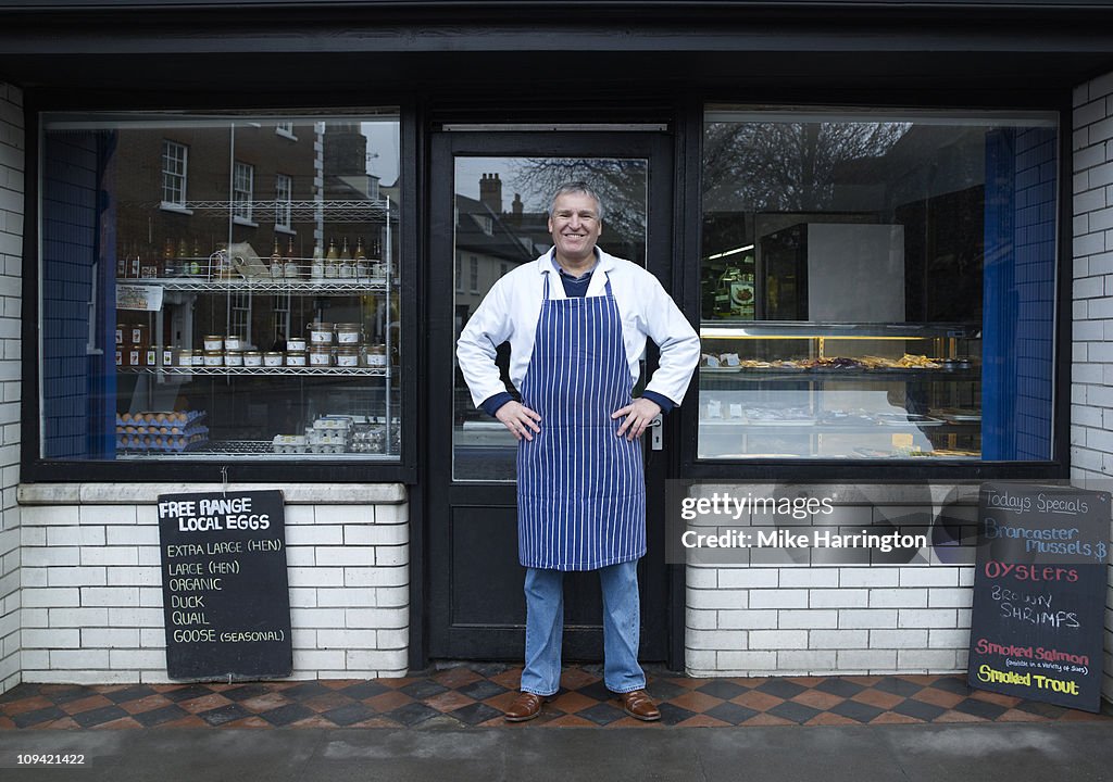 Male Fishmonger Standing Outside Shop Front