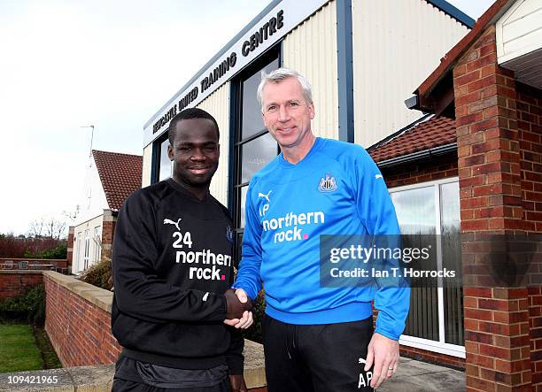 Newcastle United manager Alan Pardew shakes hands with Cheik Tiote after the midfielder agreed a new contract on February 25, 2011 in Newcastle Upon...