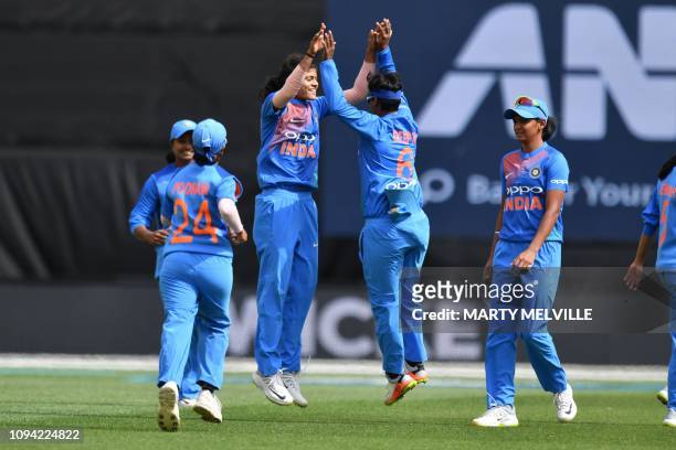 India's Radha Yadav celebrates with Deepti Sharma after taking the wicket of New Zealand's Suzie Bates during the first Twenty20 international...