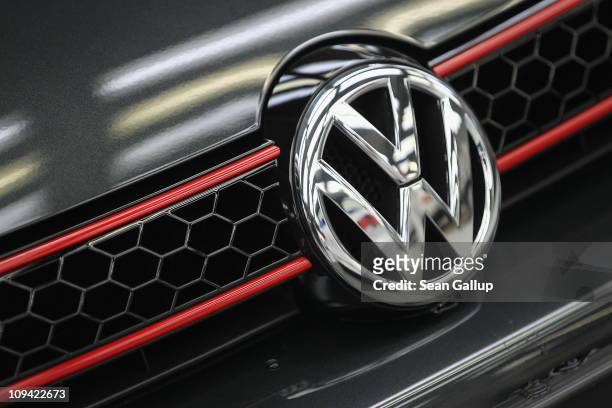 The VW logo shines as the hood ornament on a new Volkswagen Golf 6 car at the Volkswagen factory on February 25, 2011 in Wolfsburg, Germany....