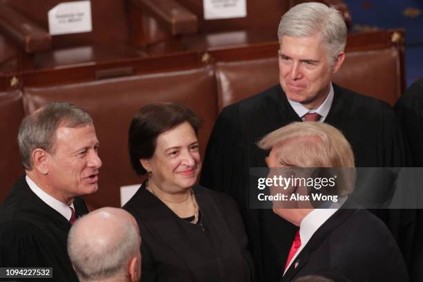 President Donald Trump greets Supreme Court Justices John Roberts, Elena Kagan, and Neil Gorsuch after the State of the Union address in the chamber...