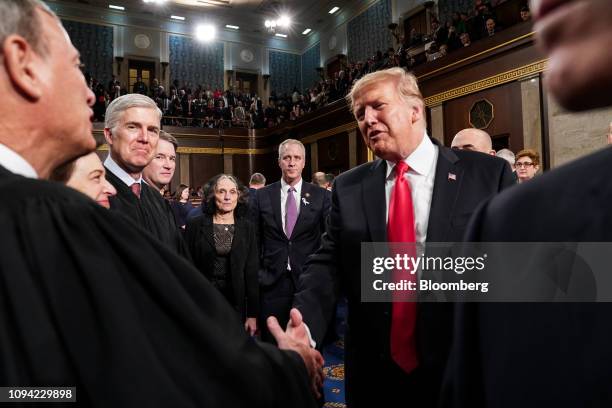 President Donald Trump, right, greets John Roberts, chief justice of the U.S. Supreme Court, as he departs after delivering a State of the Union...