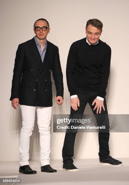 Designers Tommaso Aquilani and Roberto Rimondi acknowledge the applauses of the public after the Gianfranco Ferre fashion show as part of Milan...