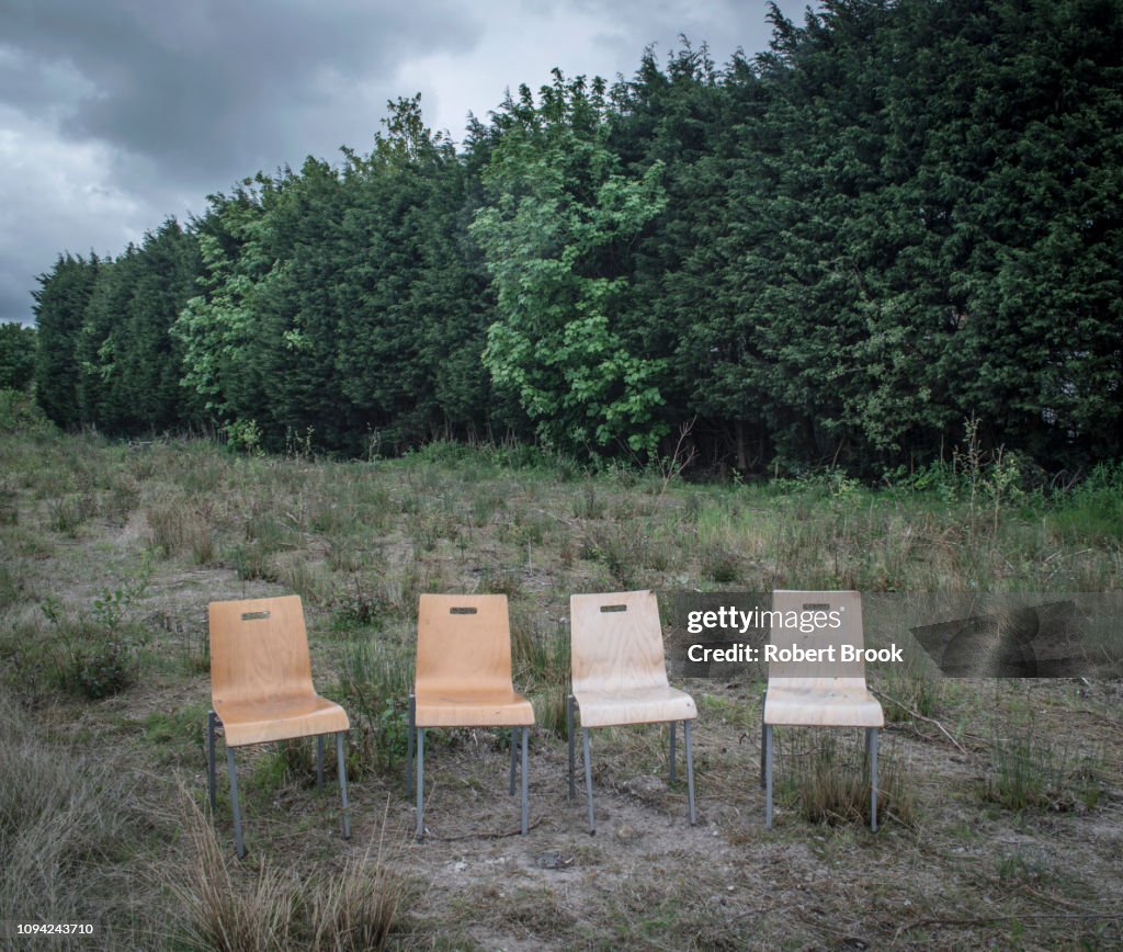 Four chairs in wasteland