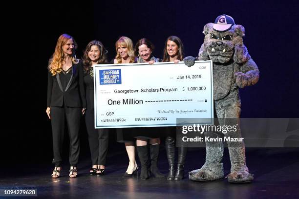 Jeannie Gaffigan, Emily Chen Carrera, Michelle Mauboussin, Chris Deacon, Missy Foy, and Georgetown University's Jack the Bulldog speak onstage during...