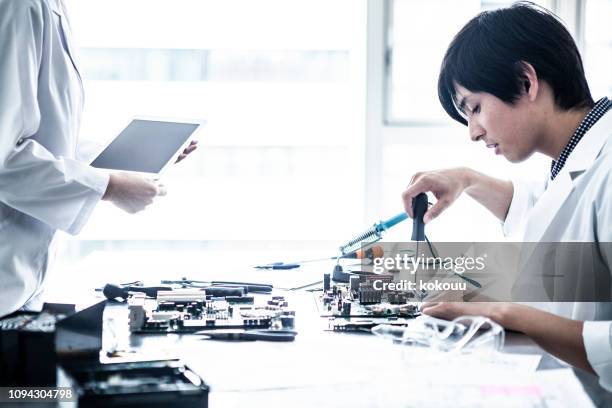 researchers who work carefully while checking the procedure. - resistor stock pictures, royalty-free photos & images