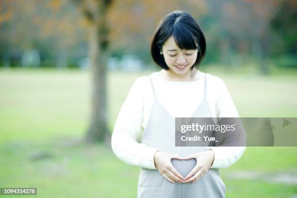 portrait of young pregnant attractive woman - fetus heart stock pictures, royalty-free photos & images