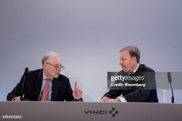 Xavier Huillard, chief executive officer of Vinci SA, left, speaks with Christian Labeyrie, chief financial officer of Vinci SA, during the company's...