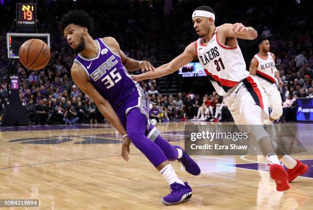 Marvin Bagley III of the Sacramento Kings and Seth Curry of the Portland Trail Blazers go for a loose ball at Golden 1 Center on January 14, 2019 in...