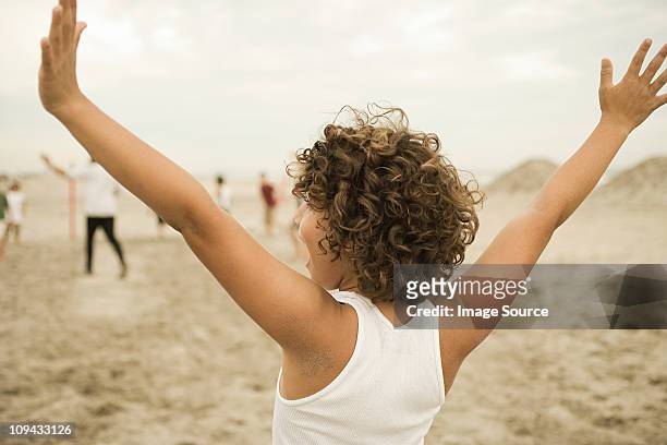 boy on beach, arms out - tank top back stock pictures, royalty-free photos & images