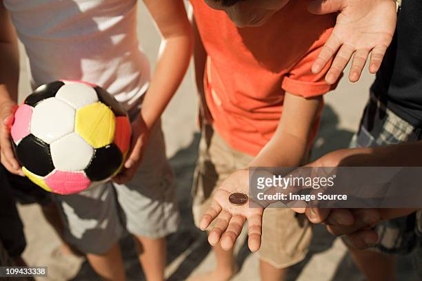 boys tossing a coin - flipping a coin stock pictures, royalty-free photos & images