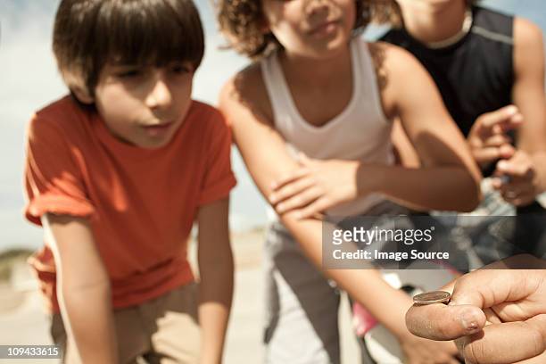 boys tossing a coin - flipping a coin stock pictures, royalty-free photos & images