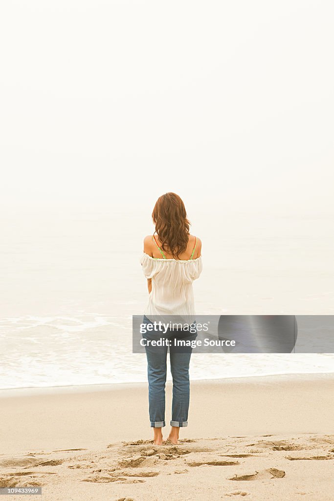 Woman standing at water's edge