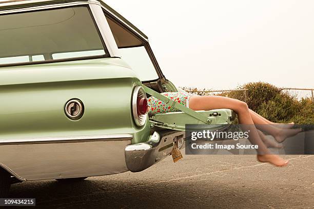two girls lying in estate car - station wagon stock pictures, royalty-free photos & images