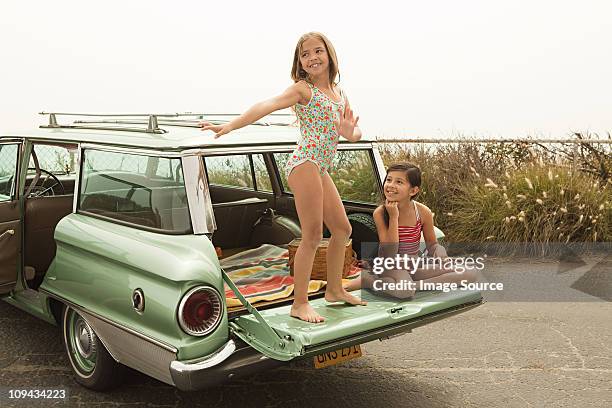 girl dancing on car boot - station wagon stock pictures, royalty-free photos & images