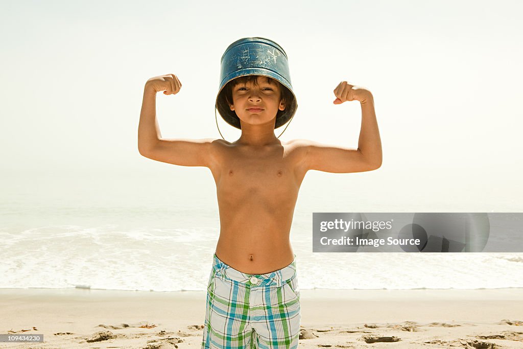 Boy With Bucket On Head Flexing Muscles High Res Stock Photo Getty Images boy-with-bucket-on-head-flexing-muscles-high-res-stock-photo-getty-images