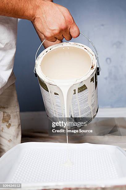 man pouring paint - paint tray stock-fotos und bilder