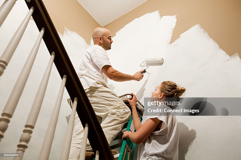 Couple painting wall