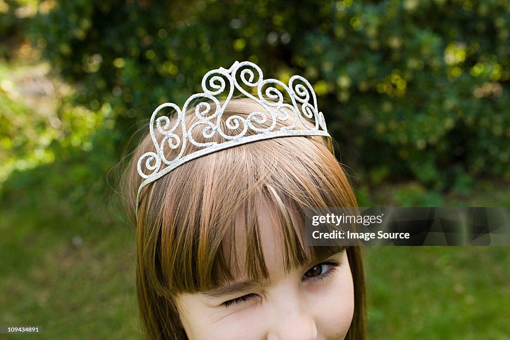 Girl wearing tiara and winking