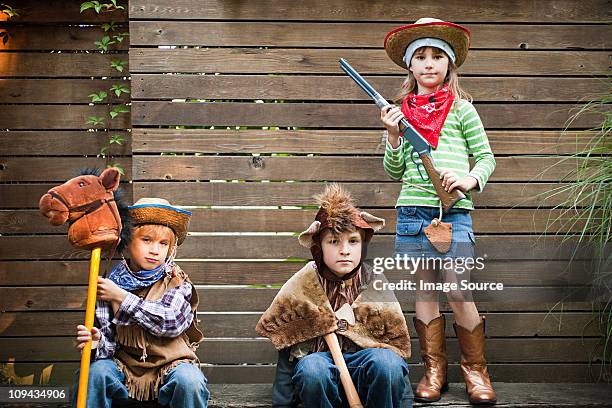 children dressed up as cowgirl, bear and cowboy - hobby horse stock pictures, royalty-free photos & images