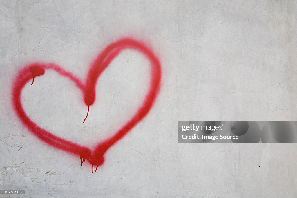 Red heart shape on white wall